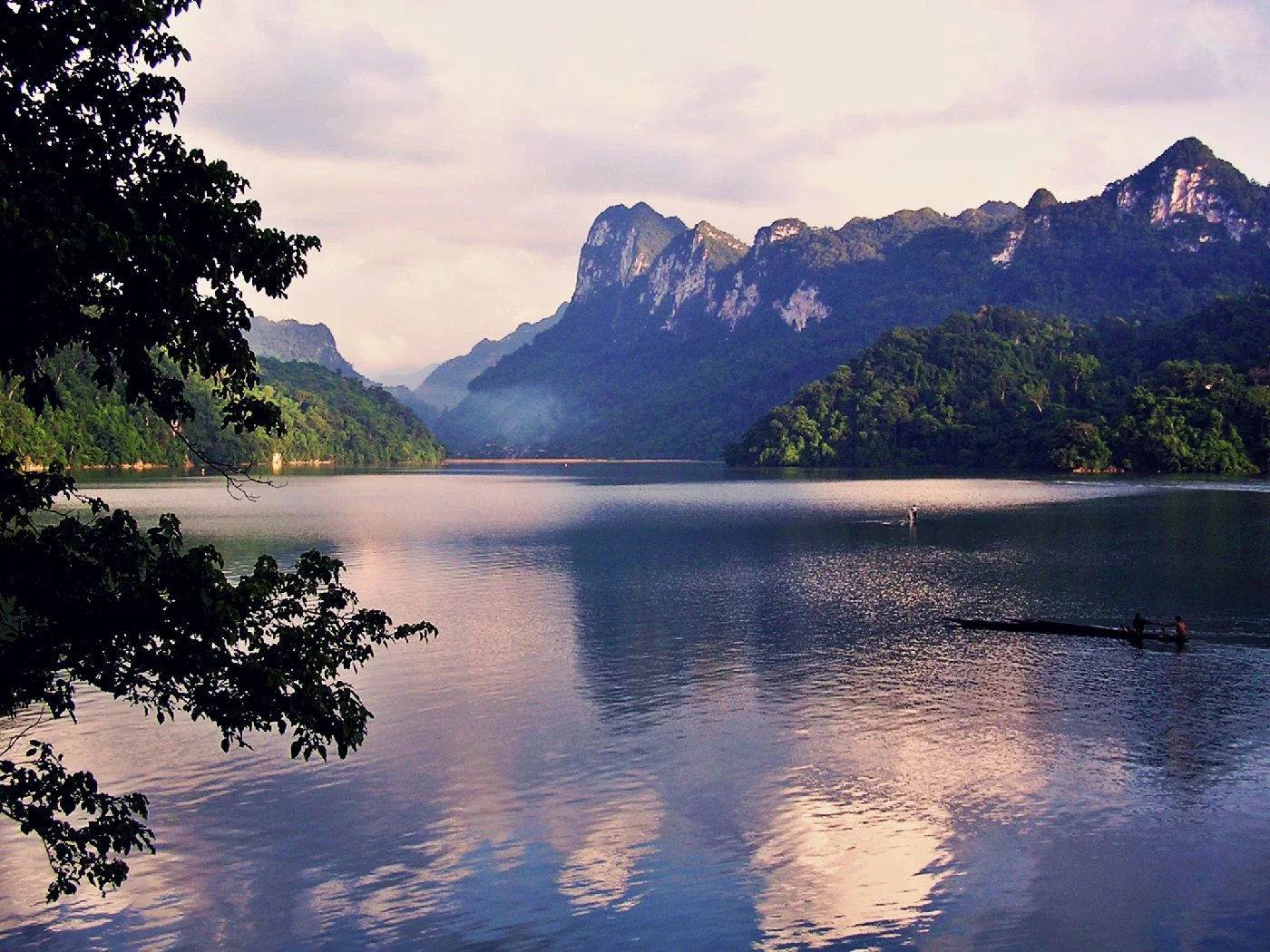Ba Be Lake at dusk framed by limestone mountains