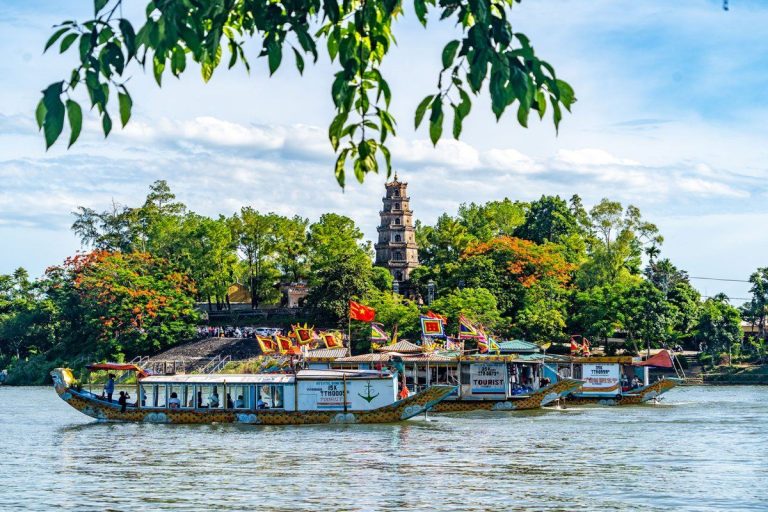 Dragon boats on the Perfume River below Thien Mu Pagoda - Rose Travel