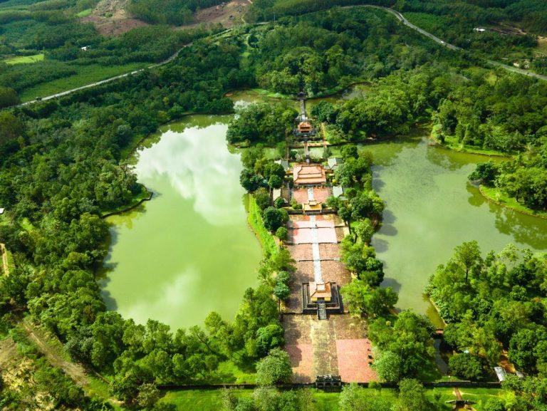 Aerial view of Minh Mang Tomb surrounded by lakes and forest - Rose Travel