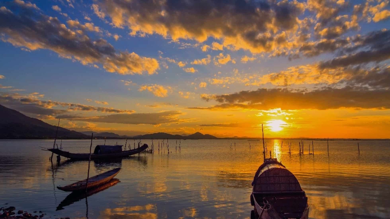 Sunset over Tam Giang Lagoon with fishing boats