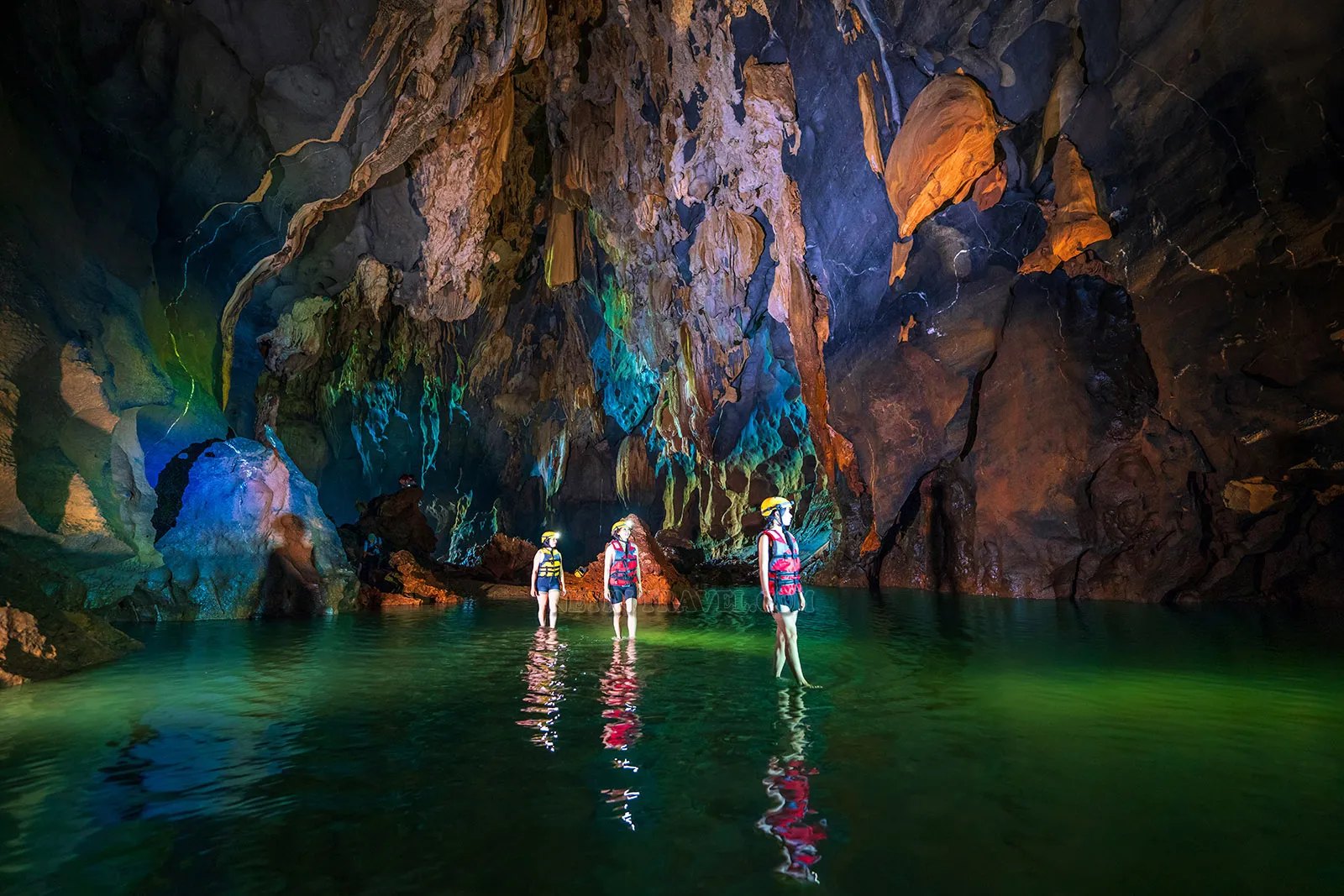 Wading through the underground river of Dark Cave (Hang Toi)